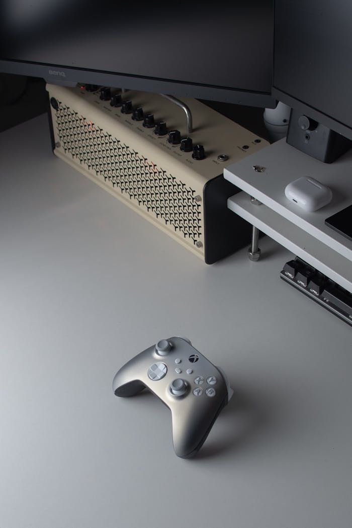 Features A sleek and modern gaming setup featuring a console controller and technology accessories in a minimalist setting.